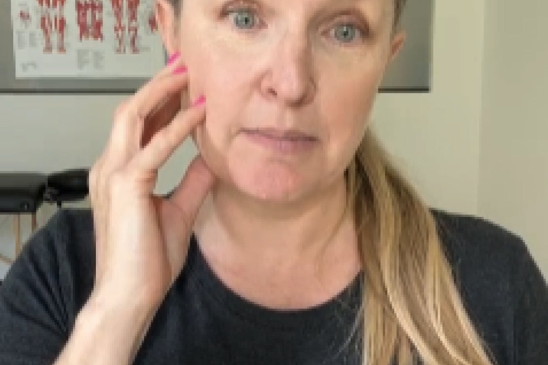 Person with jaw pain holding their face