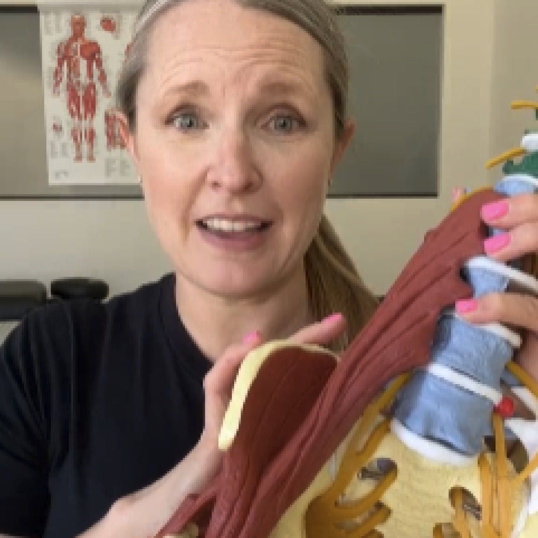 Woman holding a model of a spine with 'LOWER BACK PAIN' text above.
