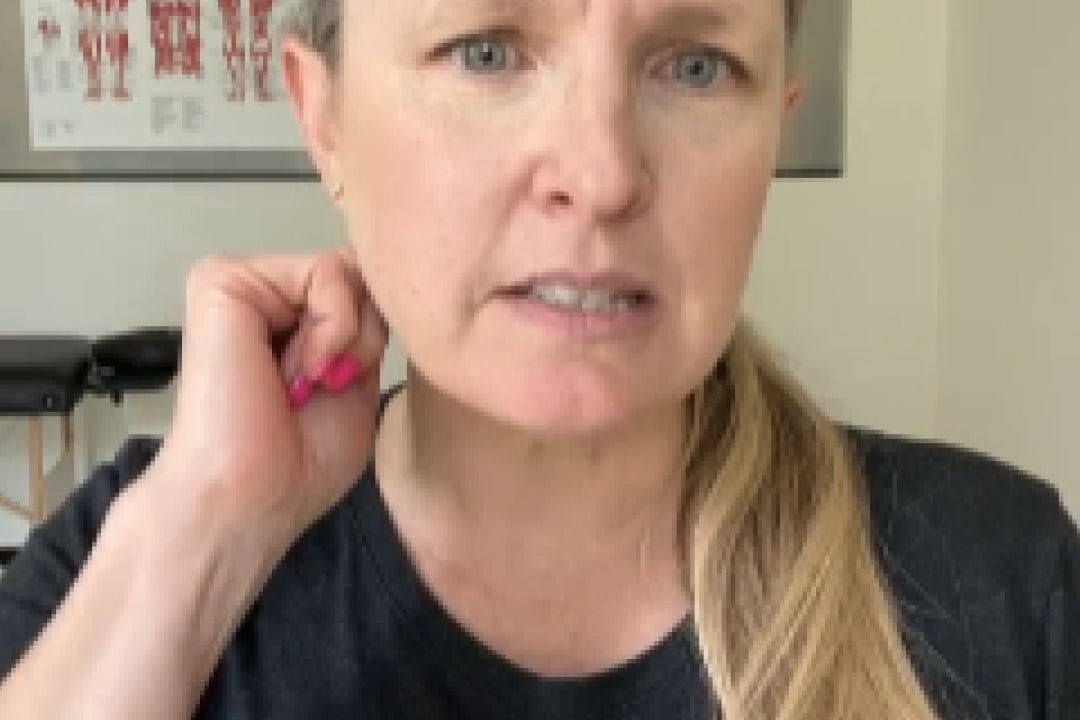Woman with neck pain holding her neck